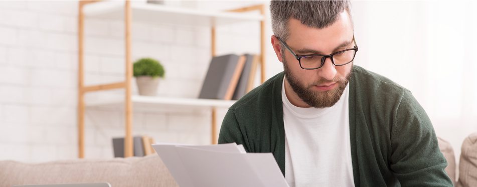 Individual concentrating on paperwork indoors