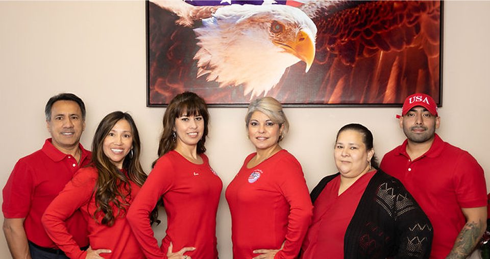 Group in red shirts with eagle painting