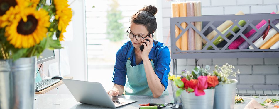 Florist working on laptop and phone